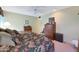 Spacious bedroom with a floral comforter, dresser and ceiling fan at 15809 N Bowling Green Dr, Sun City, AZ 85351