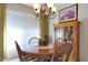 Bright dining area with a round wooden table, chairs, and built-in hutch at 15809 N Bowling Green Dr, Sun City, AZ 85351