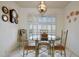 Charming dining room with a round table and four chairs, plus a window with blinds at 15809 N Bowling Green Dr, Sun City, AZ 85351