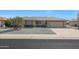 Ranch-style home with a two-car garage and landscaped front yard at 15809 N Bowling Green Dr, Sun City, AZ 85351