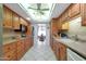 Open kitchen with ample cabinetry, granite counters, and views into dining area at 15809 N Bowling Green Dr, Sun City, AZ 85351