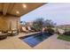 Relaxing back patio featuring lounge chairs and a modern pool design overlooking a scenic landscape at 15949 E Ridgestone Dr, Fountain Hills, AZ 85268