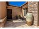 Private courtyard with a small table and chairs, large pot, and stone flooring at 16442 W Berkeley Rd, Goodyear, AZ 85395