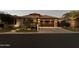 Single-story home with stucco and tile roof at dusk, landscaping, and a two-car garage at 16442 W Berkeley Rd, Goodyear, AZ 85395