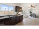 Kitchen features dark wood cabinets, granite counters, and a view of the dining area at 1721 S 64Th Ave, Phoenix, AZ 85043