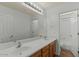 Bathroom featuring double sinks, a spacious counter, and a well-lit vanity, next to a separate toilet and shower room at 17750 W Watson Ln, Surprise, AZ 85388