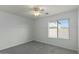 Bedroom with ample natural light, plush carpeting, and a ceiling fan, creating a relaxing and welcoming atmosphere at 17750 W Watson Ln, Surprise, AZ 85388