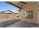 Covered patio with ceiling fan extends living space to the outdoors with views of the low maintenance backyard at 17750 W Watson Ln, Surprise, AZ 85388