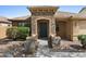 Welcoming front entrance with a stone-accented porch and a well-maintained yard offering a warm first impression at 17750 W Watson Ln, Surprise, AZ 85388