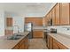 Well-equipped kitchen with stainless steel appliances, tile floors and bright lighting, great for cooking and Gathering time at 17750 W Watson Ln, Surprise, AZ 85388