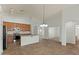 Open-concept kitchen with light wood cabinets, stainless steel appliances, island and lots of natural light at 17750 W Watson Ln, Surprise, AZ 85388