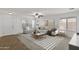 Open-concept living room featuring neutral tones, contemporary furnishings, and lots of natural light at 17750 W Watson Ln, Surprise, AZ 85388