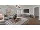Bright living room featuring contemporary furnishings, stylish decor and a modern ceiling fan at 17750 W Watson Ln, Surprise, AZ 85388