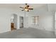 Spacious main bedroom featuring neutral carpet, ceiling fan and ensuite bath with dual sinks at 17750 W Watson Ln, Surprise, AZ 85388