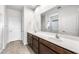 Bathroom featuring double sinks, a large mirror, and a glass-enclosed shower at 17857 W Getty Dr, Goodyear, AZ 85338