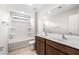 Bathroom features dual sinks, dark wood cabinets, and a shower-tub combo at 17857 W Getty Dr, Goodyear, AZ 85338