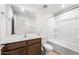 Bathroom features a vanity with dark wood cabinets, toilet, tub, and shower at 17857 W Getty Dr, Goodyear, AZ 85338