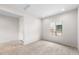 Bright bedroom with carpet flooring, a large window, and neutral wall paint at 17857 W Getty Dr, Goodyear, AZ 85338