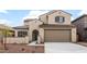 Charming two-story home featuring stucco siding, a tiled roof, and a two-car garage at 17857 W Getty Dr, Goodyear, AZ 85338