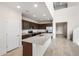 Contemporary kitchen featuring stainless steel appliances, granite counters, and pendant lighting at 17857 W Getty Dr, Goodyear, AZ 85338