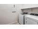 Laundry room features a new washer and dryer with storage shelf at 17857 W Getty Dr, Goodyear, AZ 85338