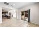 Living area with sliding glass door, tile floors, and open concept to kitchen at 17857 W Getty Dr, Goodyear, AZ 85338