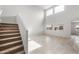 Open-concept living space featuring high ceilings, large windows, and staircase at 17857 W Getty Dr, Goodyear, AZ 85338
