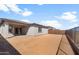 Spacious backyard with a covered patio and secure fence, providing a private outdoor living space at 17875 W Getty Dr, Goodyear, AZ 85338