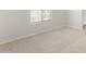 Cozy bedroom featuring neutral carpeting, a window with blinds, and fresh paint at 17875 W Getty Dr, Goodyear, AZ 85338
