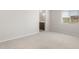 A spacious bedroom featuring soft carpet and a view of the bathroom at 17875 W Getty Dr, Goodyear, AZ 85338