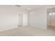 A bright, neutral bedroom with an open doorway and carpet flooring at 17875 W Getty Dr, Goodyear, AZ 85338
