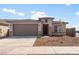 Beautiful single-story home with a well-manicured front yard and a two car attached garage at 17875 W Getty Dr, Goodyear, AZ 85338