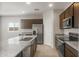 Modern kitchen showcasing granite countertops, stainless steel appliances, and wooden cabinetry at 17875 W Getty Dr, Goodyear, AZ 85338