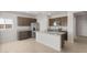 Bright kitchen with an island, stainless appliances, wood cabinets, and tile flooring at 17875 W Getty Dr, Goodyear, AZ 85338