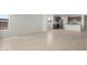 Inviting living room with tile floors, fresh paint, and an open layout connecting to kitchen at 17875 W Getty Dr, Goodyear, AZ 85338