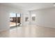 Spacious living room with sliding doors and tile floors, providing a welcoming space at 17875 W Getty Dr, Goodyear, AZ 85338
