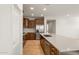 Modern kitchen with wood cabinets and a large island at 17876 W Encinas Ln, Goodyear, AZ 85338