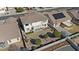 An aerial view of the backyard featuring desert landscaping, a patio, a small balcony, and a privacy fence at 18017 W Desert Ln, Surprise, AZ 85388