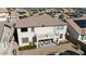 Back exterior view with upper deck, covered patio and brick pavers at 18017 W Desert Ln, Surprise, AZ 85388