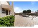 Spacious backyard with brick patio, shaded seating, and mature landscaping for privacy and enjoyment at 18017 W Desert Ln, Surprise, AZ 85388