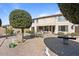 Backyard featuring a patio with seating, desert landscaping, and privacy fencing at 18017 W Desert Ln, Surprise, AZ 85388