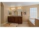 Bright bathroom featuring a double vanity, soaking tub, and stylish lighting fixtures at 18017 W Desert Ln, Surprise, AZ 85388