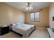 Cozy bedroom with neutral walls, carpet flooring, and a bright window for natural light at 18017 W Desert Ln, Surprise, AZ 85388
