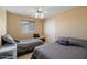 Bedroom featuring two twin beds with matching bedding and a mirrored closet door at 18017 W Desert Ln, Surprise, AZ 85388