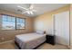 Bedroom featuring neutral walls, a ceiling fan, and a sunny window view at 18017 W Desert Ln, Surprise, AZ 85388