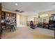 Spacious bonus room featuring built-in bookshelves, and neutral carpet at 18017 W Desert Ln, Surprise, AZ 85388