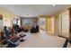 Spacious bonus room featuring carpet, a tv area, seating and natural light at 18017 W Desert Ln, Surprise, AZ 85388