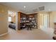 Large bonus room featuring built-in bookshelves, and neutral carpet at 18017 W Desert Ln, Surprise, AZ 85388