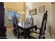 This formal dining room features neutral paint, carpet floors, and elegant decor and lighting at 18017 W Desert Ln, Surprise, AZ 85388