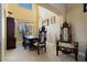 This formal dining room features neutral paint, carpet floors, elegant decor and lighting, and many windows at 18017 W Desert Ln, Surprise, AZ 85388